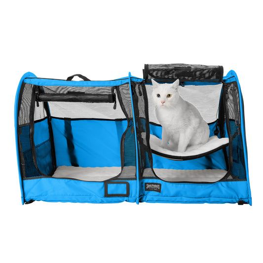 Blue CarGo double pop-up kennel with mesh doors, a white cat inside, and soft bedding.