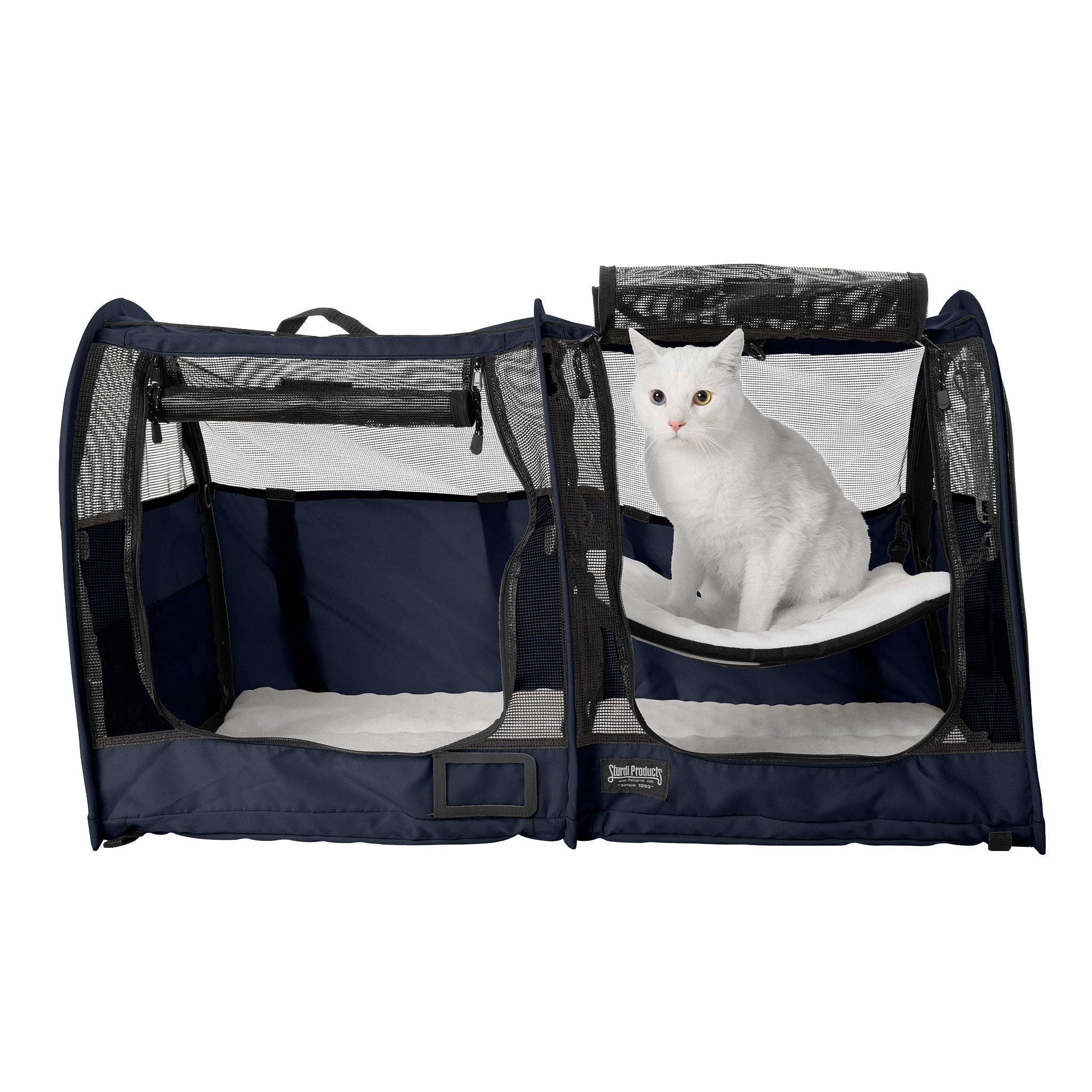 Navy blue CarGo double pop-up kennel with mesh doors, a white cat on an internal hammock, and soft white pads.