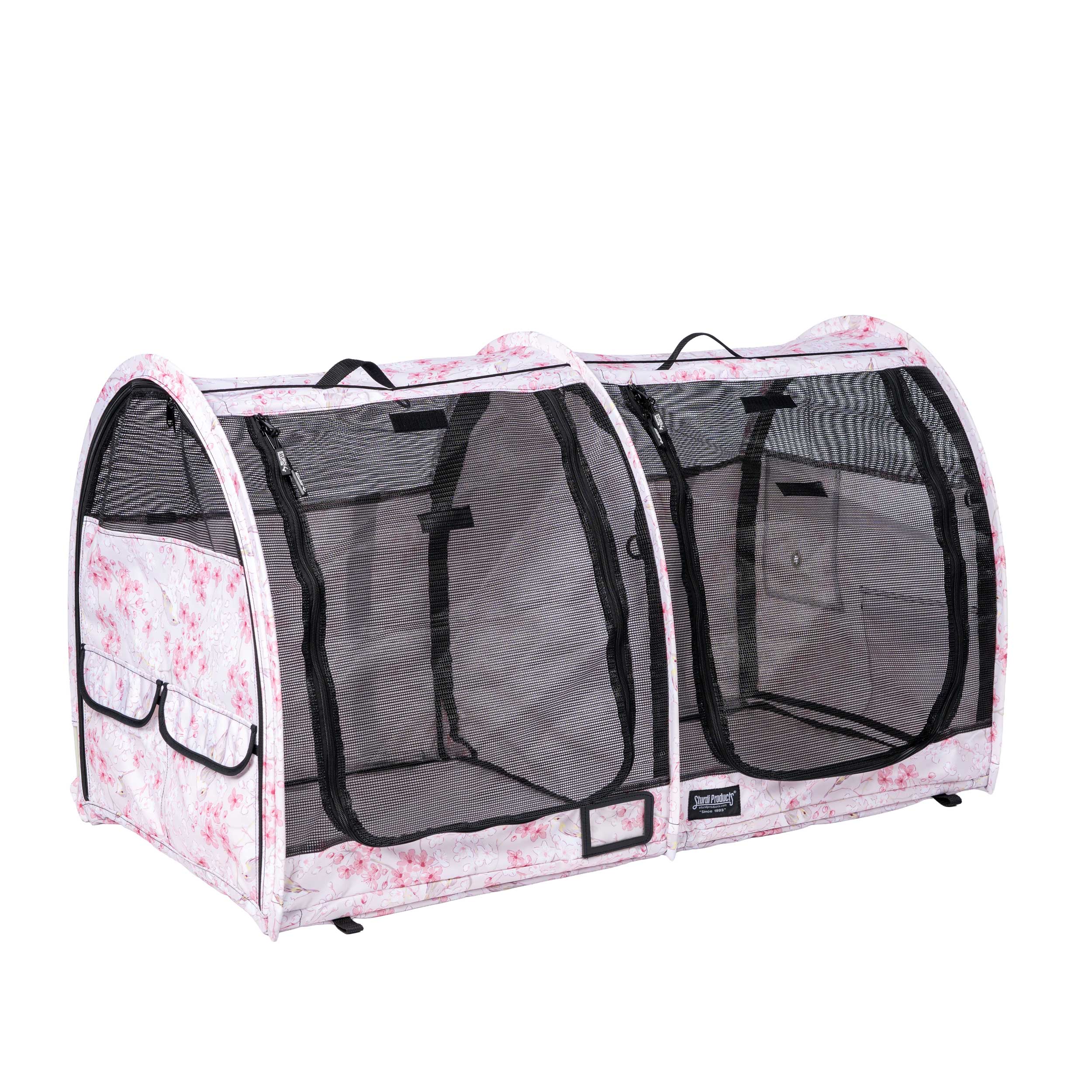 Pink floral CarGo double pop-up pet kennel with mesh doors, storage pockets, and black handles.