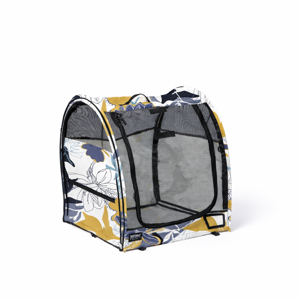 Midnight Bloom Champion Pop-Up Kennel with white, yellow, and blue floral design, black mesh, and zippers.