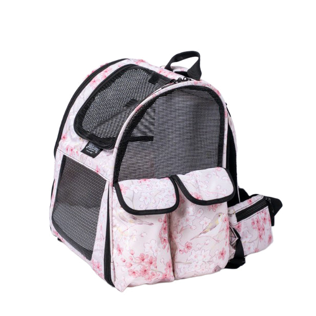 Pink pet backpack with cherry blossom print, black mesh windows, and side pockets.