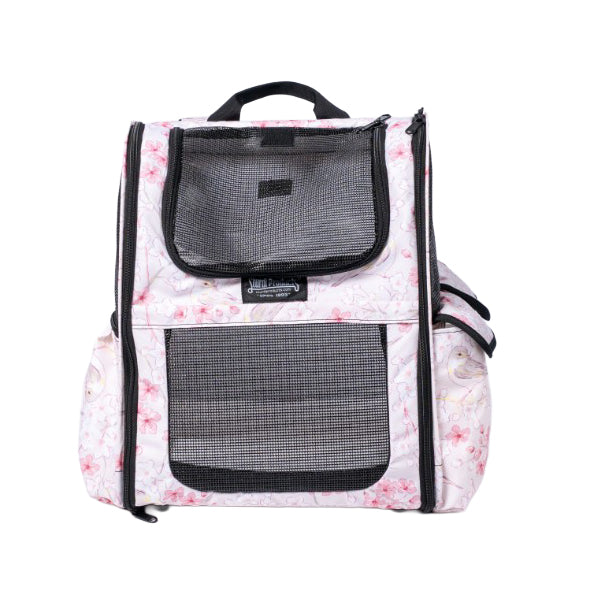 White pet backpack with pink floral print, black mesh windows, and top handle.