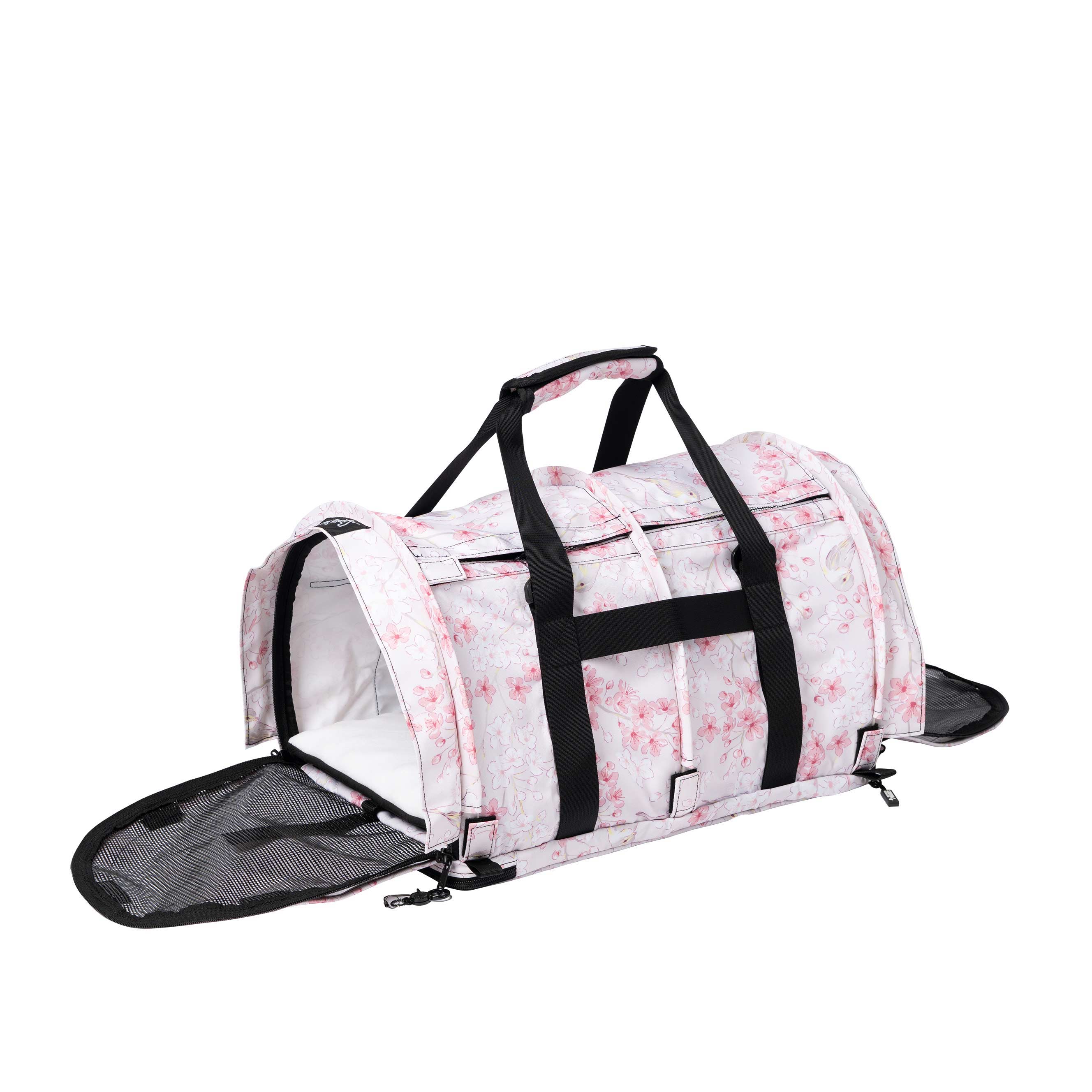 Pink and white Sakura Nest pet carrier with cherry blossom print, black handles, and mesh side opening.