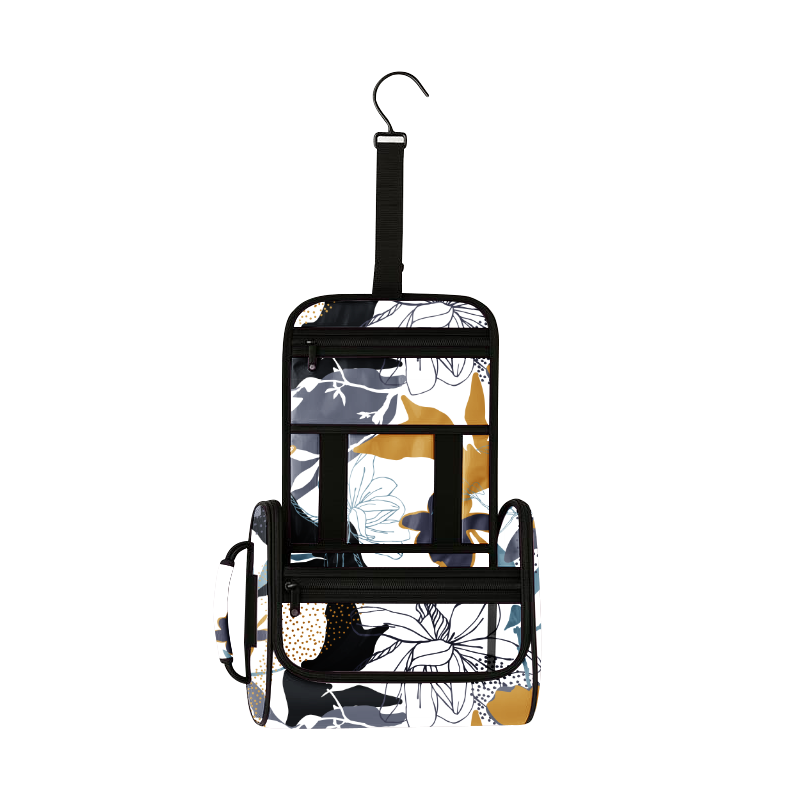 Hanging toiletry organizer with black, white, gold, and blue floral pattern, multiple clear vinyl pockets, and a hook.