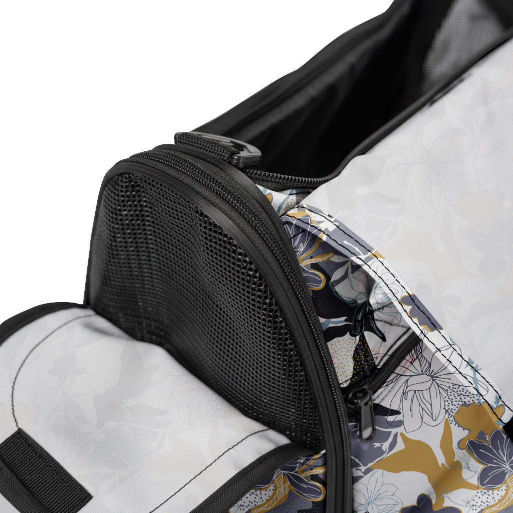 Close-up of a discreet pet travel tote with a black mesh window and a stylish floral pattern.