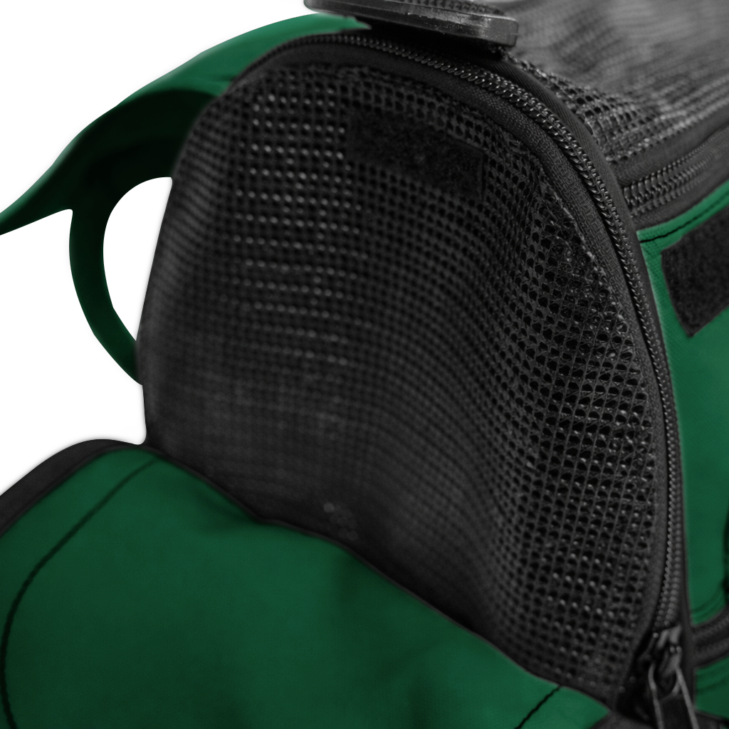 Close-up of a dark green pet travel tote with black mesh ventilation and a zipper closure.
