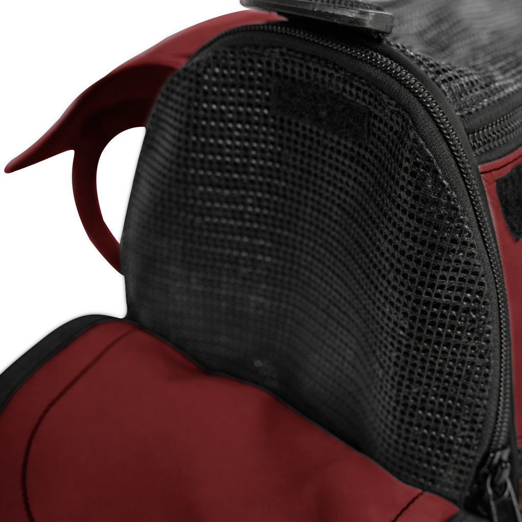 Close-up of a burgundy Incognito pet travel tote with black mesh window and zipper.
