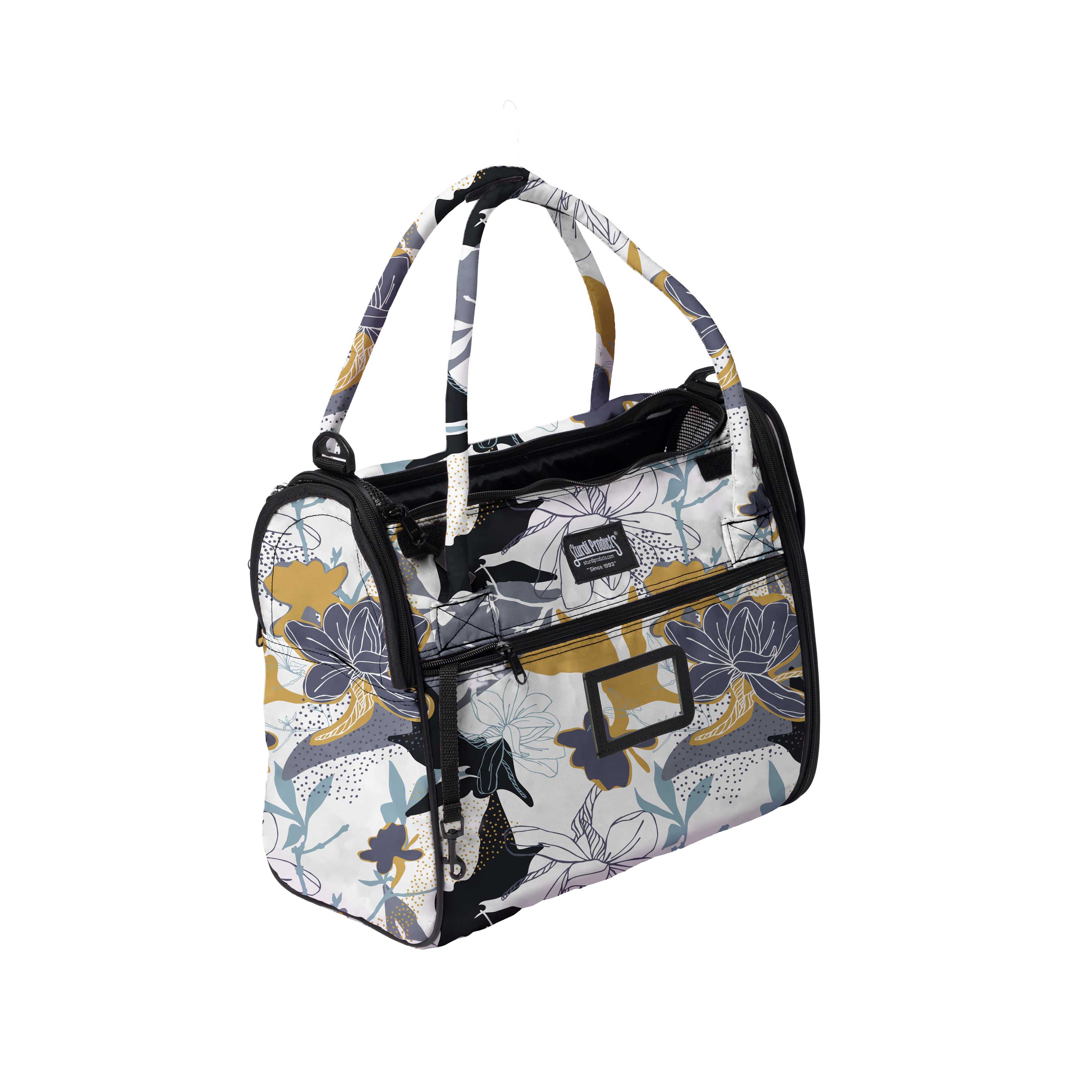 Stylish Incognito pet travel tote with a white, gold, and blue floral pattern, multiple zippers, and top handles.