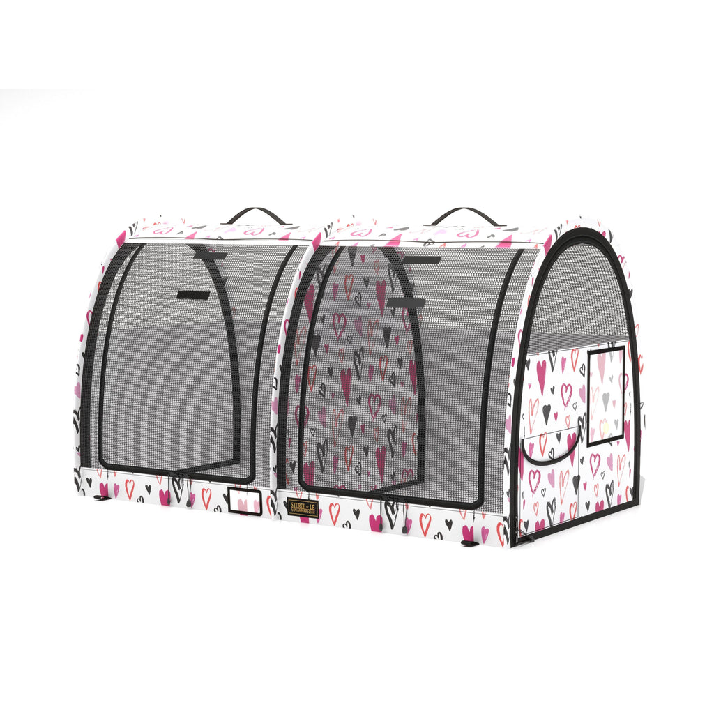 White pop-up double pet kennel with pink and black heart print, mesh doors, and carrying handles.
