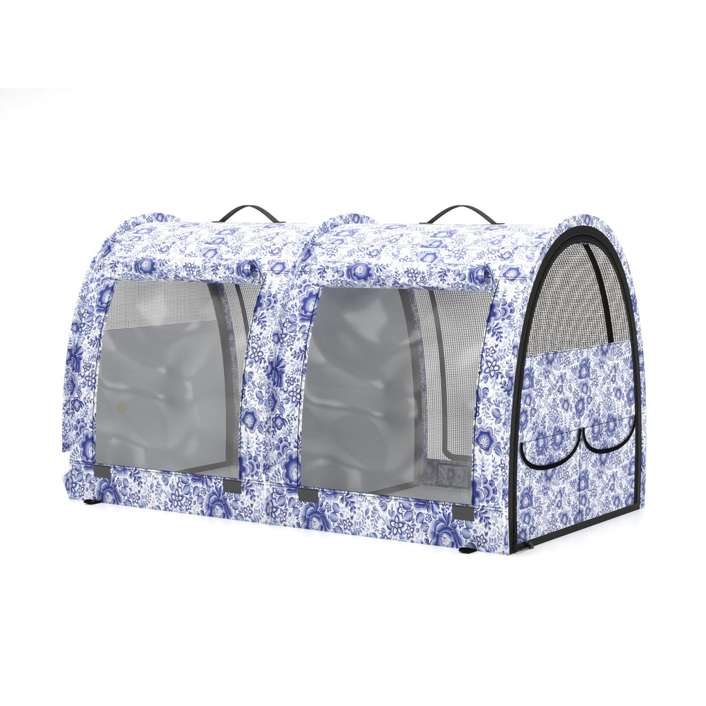 Double pop-up pet kennel in white and blue floral print with mesh windows and black handles.