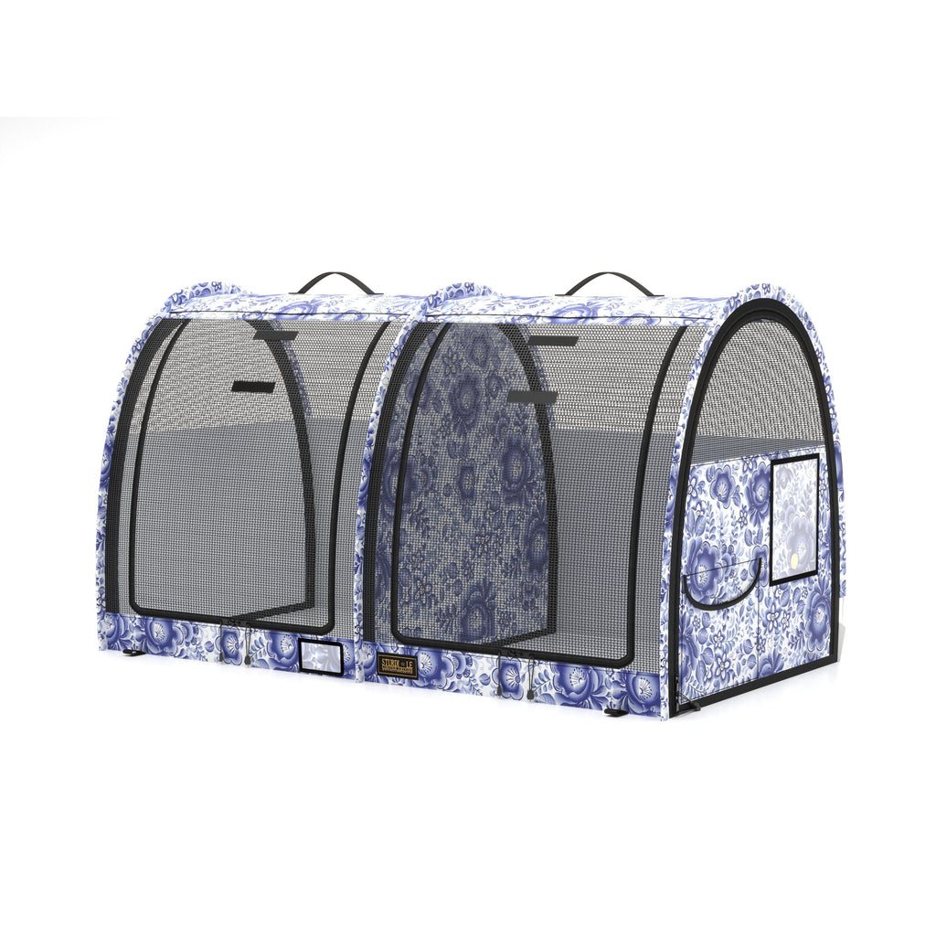 Blue and white floral print double pop-up pet kennel with mesh doors and black handles.