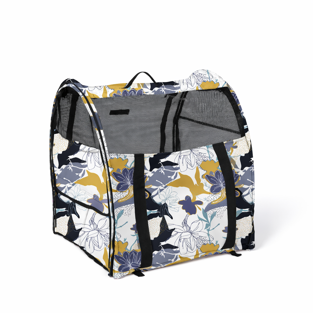 Modular portable pop-up kennel with a white, blue, and yellow floral pattern, mesh doors, and black straps.