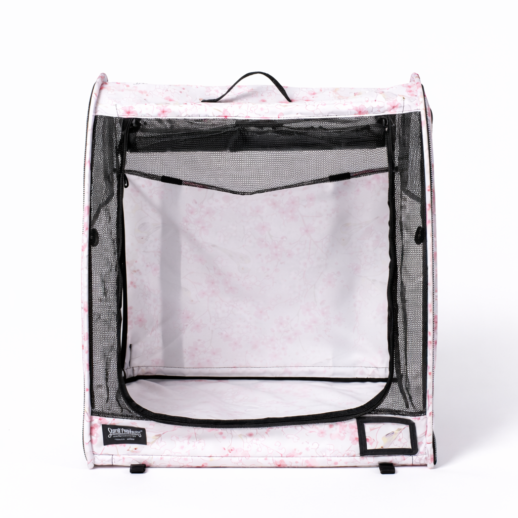 Pink cherry blossom patterned modular pop-up pet kennel with black mesh door and top handle.