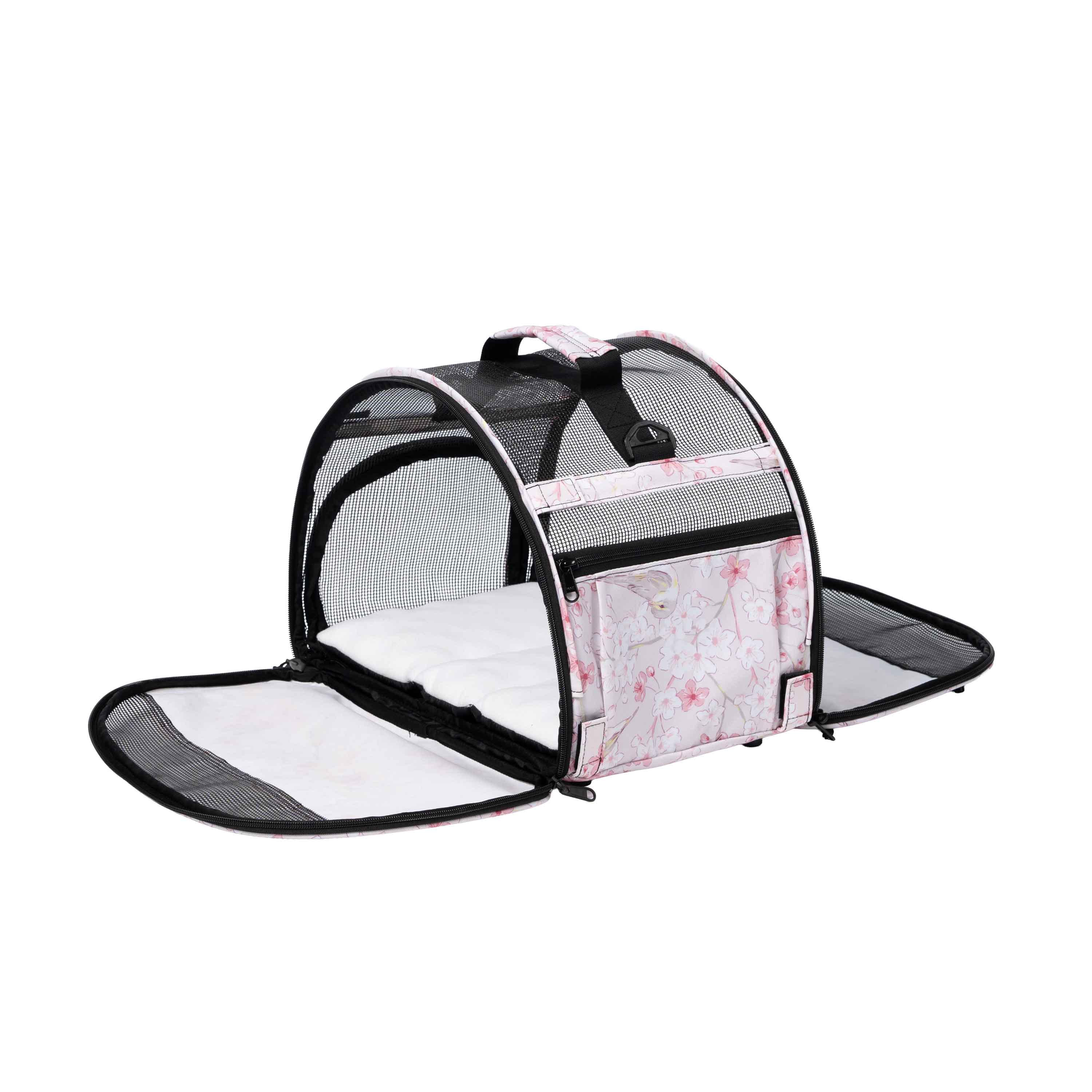 Pink floral pet carrier with mesh sides, a white fleece pad, and open end flaps.