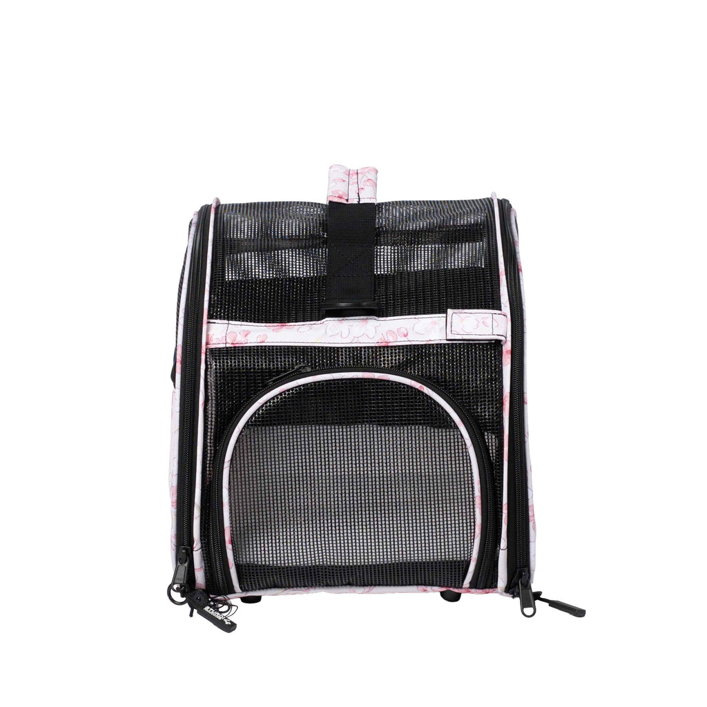 Pink and white patterned Totes'ter compact pet carrier with black mesh panels and top privacy flap.