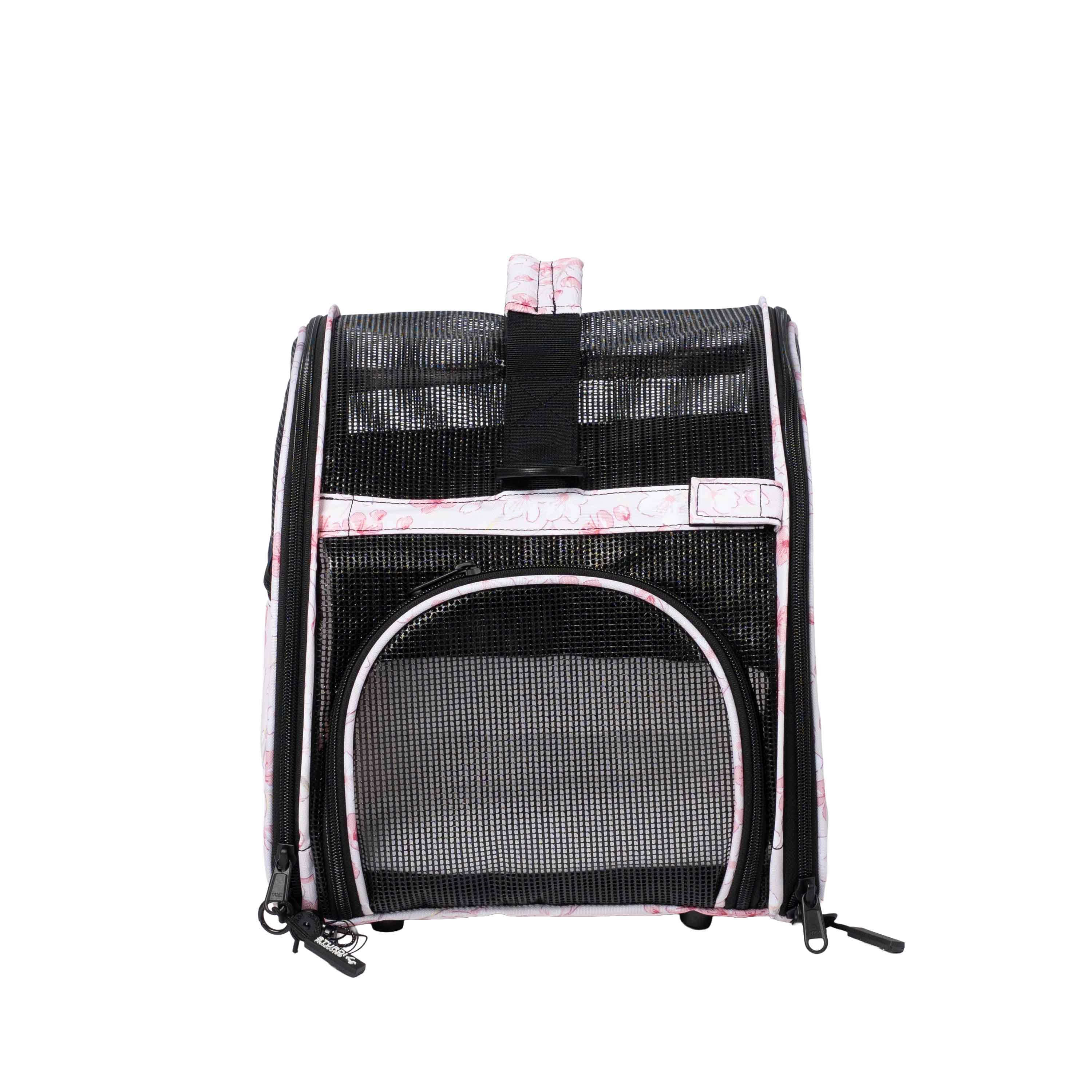 Pink and white patterned Totes'ter compact pet carrier with black mesh panels and top privacy flap.