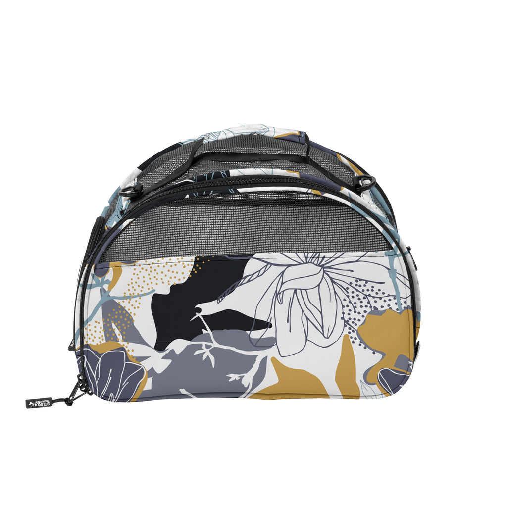 Compact pet carrier in a limited edition floral print with mesh panels and top handle.
