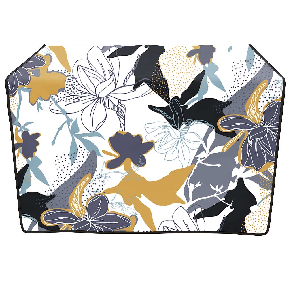 White grooming table skirt with a modern floral pattern in gold, black, and blue.