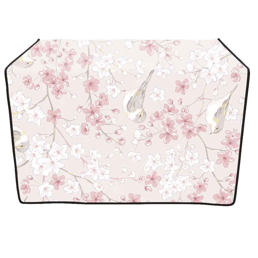 Light pink grooming table skirt with white and pink cherry blossoms and small birds.