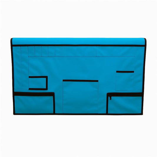 Bright blue pet grooming table skirt with multiple black-trimmed storage pockets and zippered pouches.