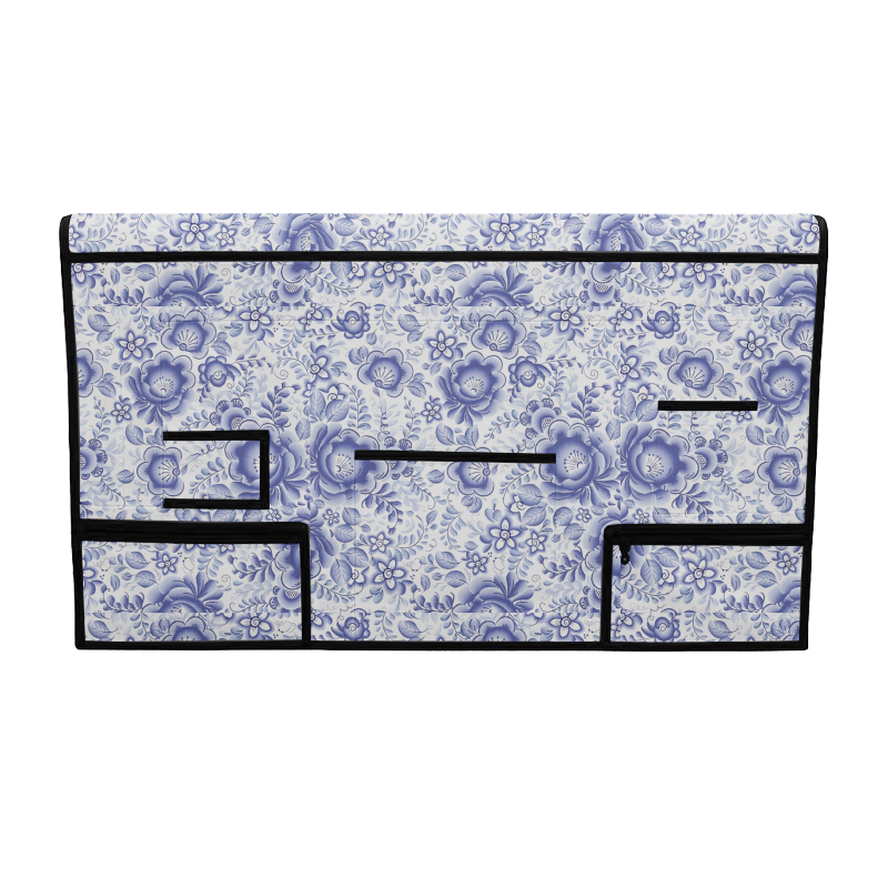 Blue and white floral pet grooming table skirt with multiple storage pockets and black trim.