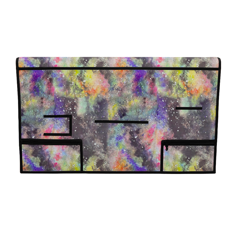 Colorful pet grooming table skirt with multiple pockets, black trim, and a galaxy-like splatter pattern.