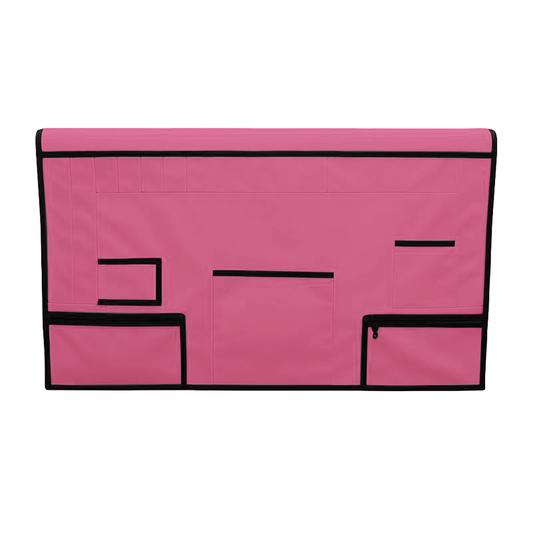 Pink pet grooming table skirt with black trim, multiple pockets, and zippered pouches.