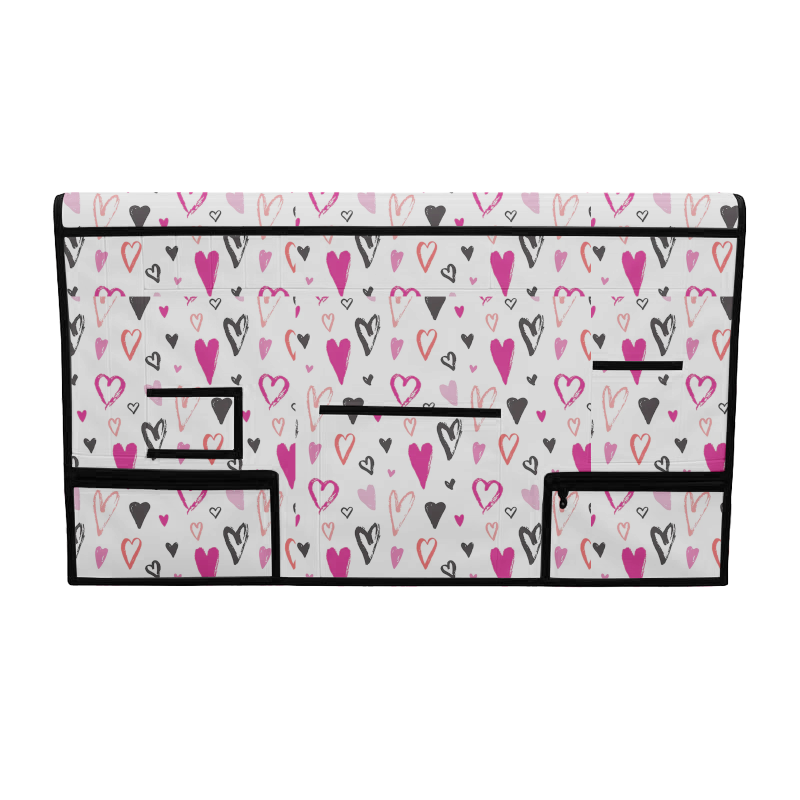 White pet grooming table skirt with pink, red, and black heart pattern, featuring multiple storage pockets.