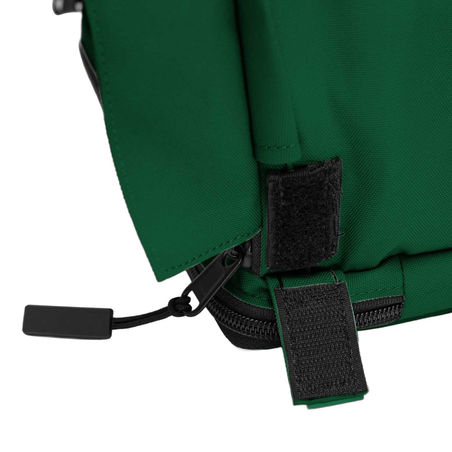 Close-up of a dark green fabric SturdiBag with a black zipper and velcro straps.