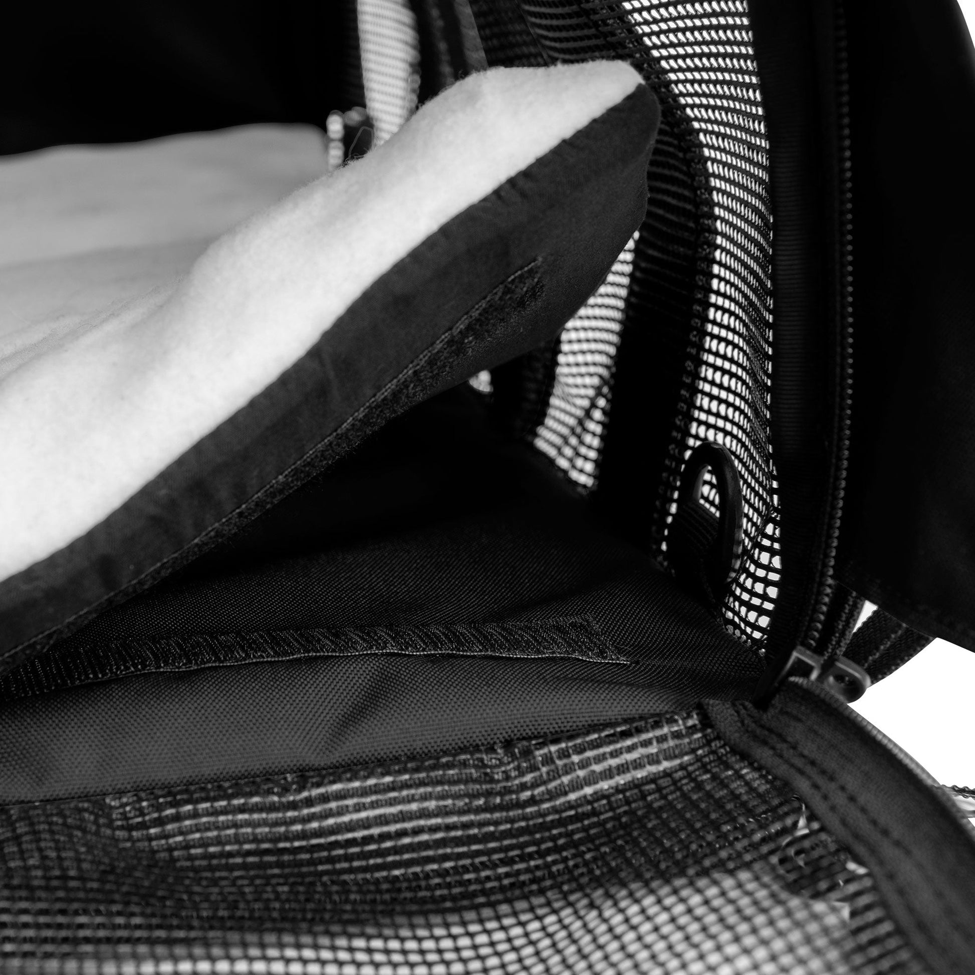 Black SturdiBag All Mesh Pet Carrier interior with a soft, white fleece comfort pad and breathable mesh panels.