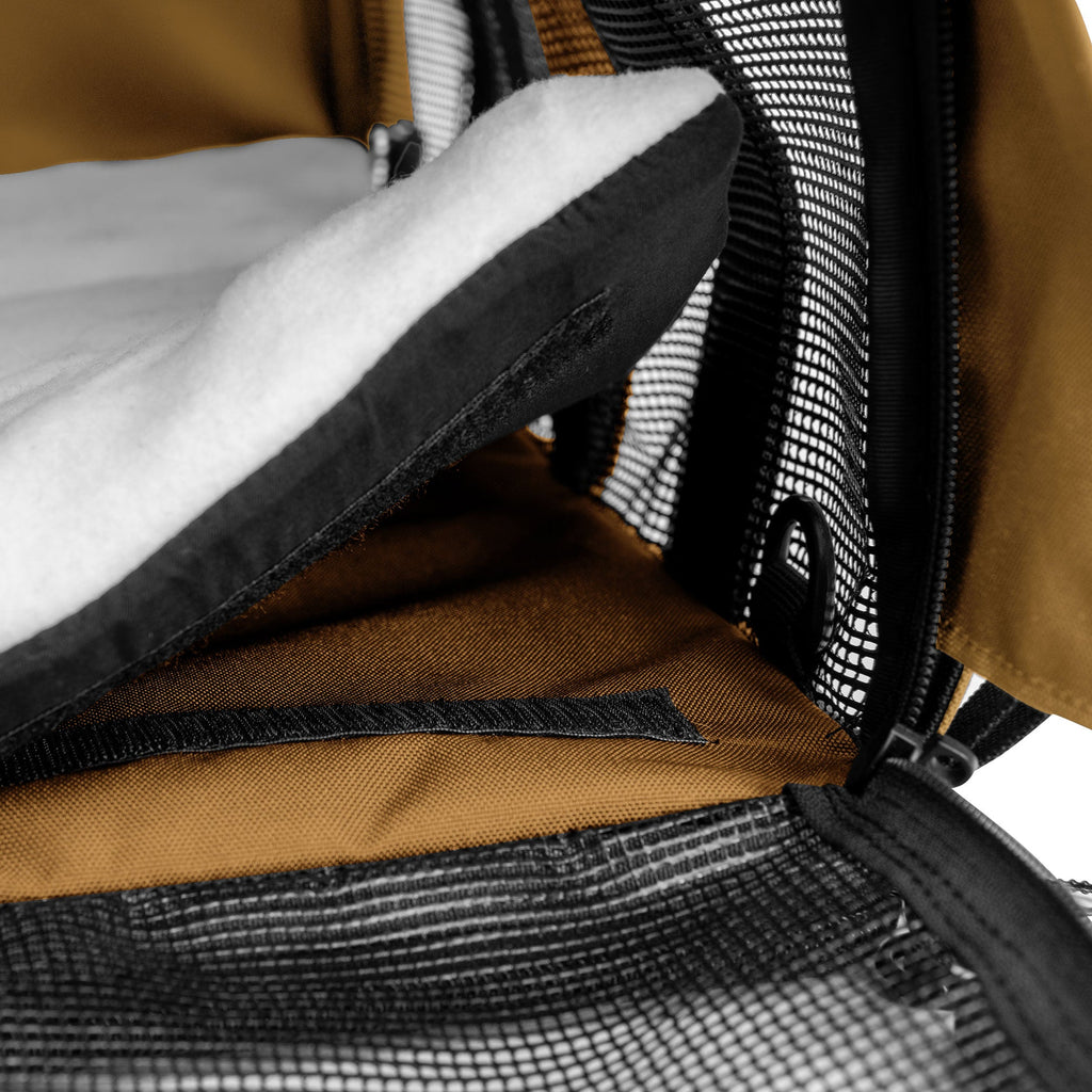 Brown SturdiBag All Mesh Pet Carrier with black mesh, zipper, and white fleece comfort pad visible inside.