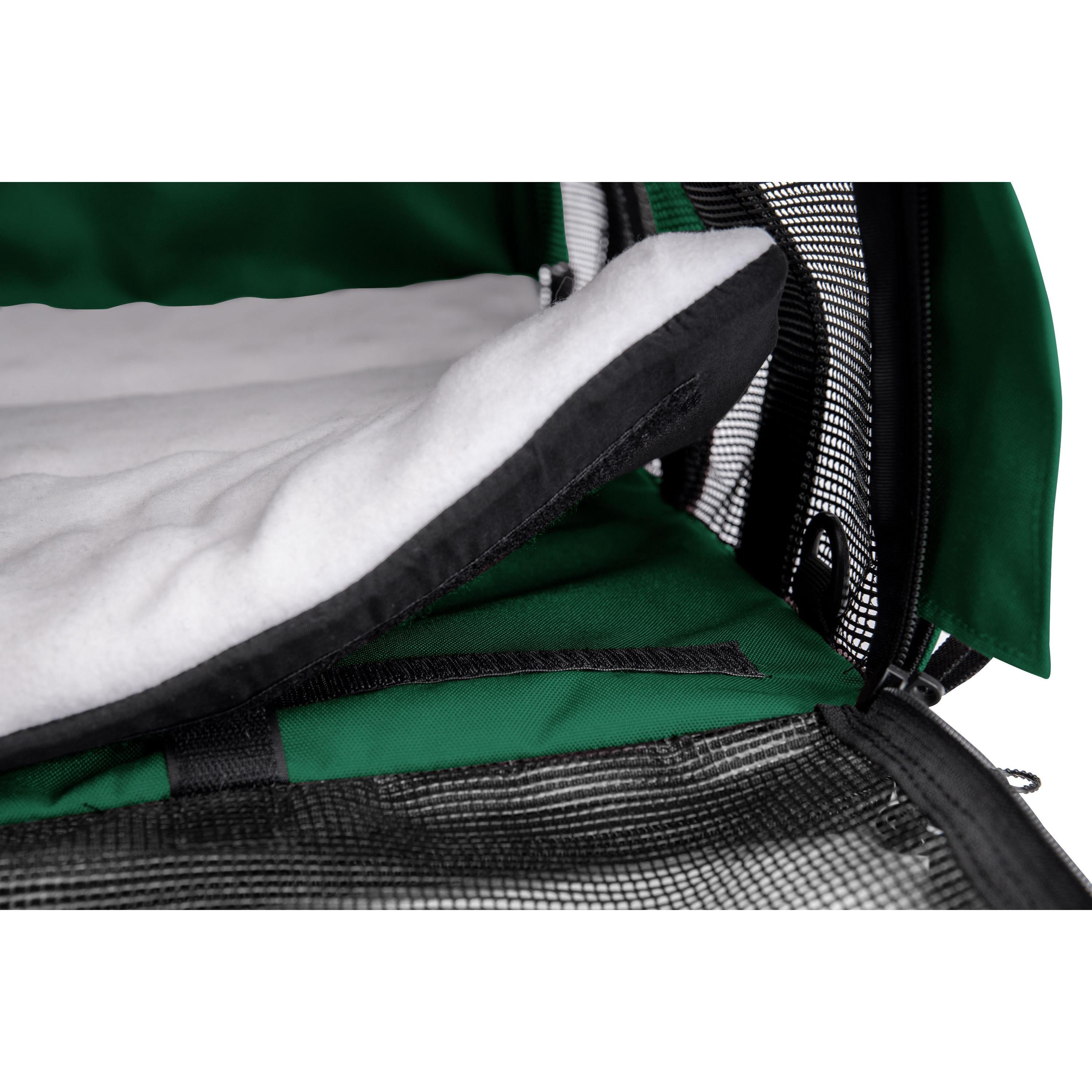 Close-up of a green SturdiBag Pro 3.0 divided pet carrier with a white fleece pad and black mesh.