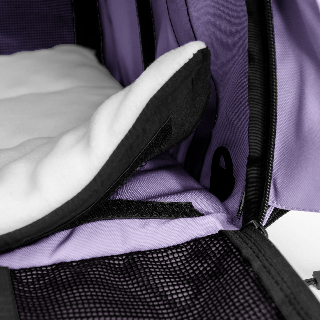 Purple SturdiBag Pro 3.0 divided pet carrier with soft white fleece bedding and mesh panel.