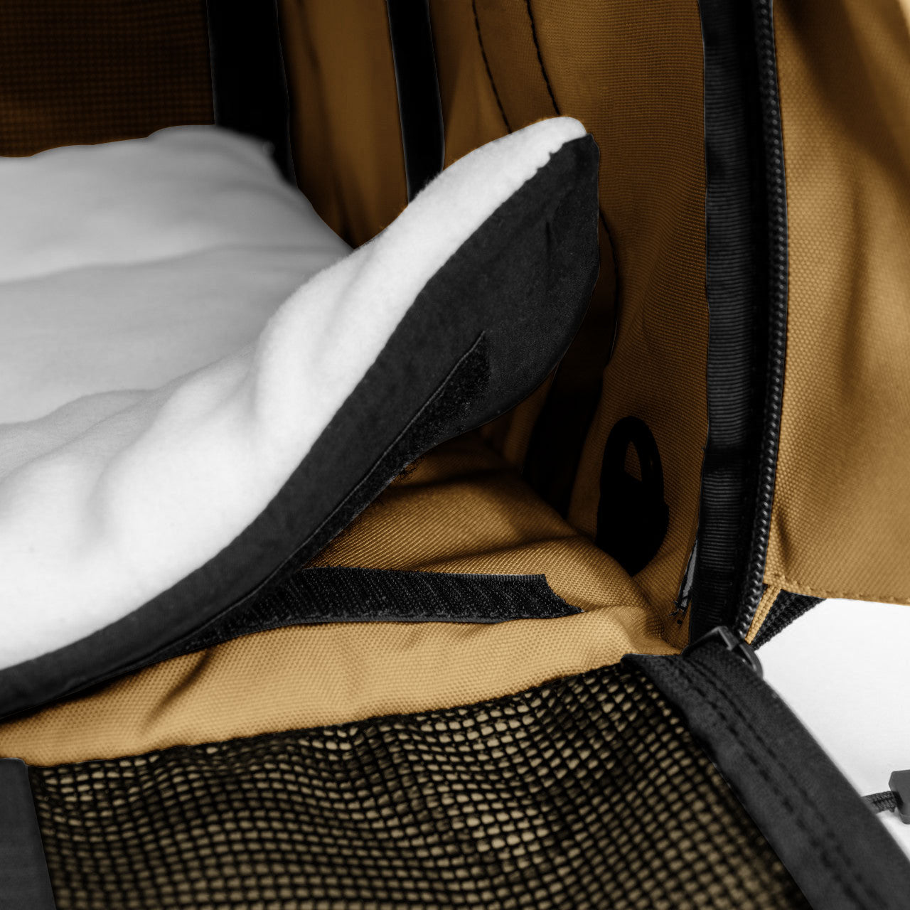 SturdiBag Pro 3.0 pet carrier interior with a soft white fleece pad, tan fabric, and black mesh.