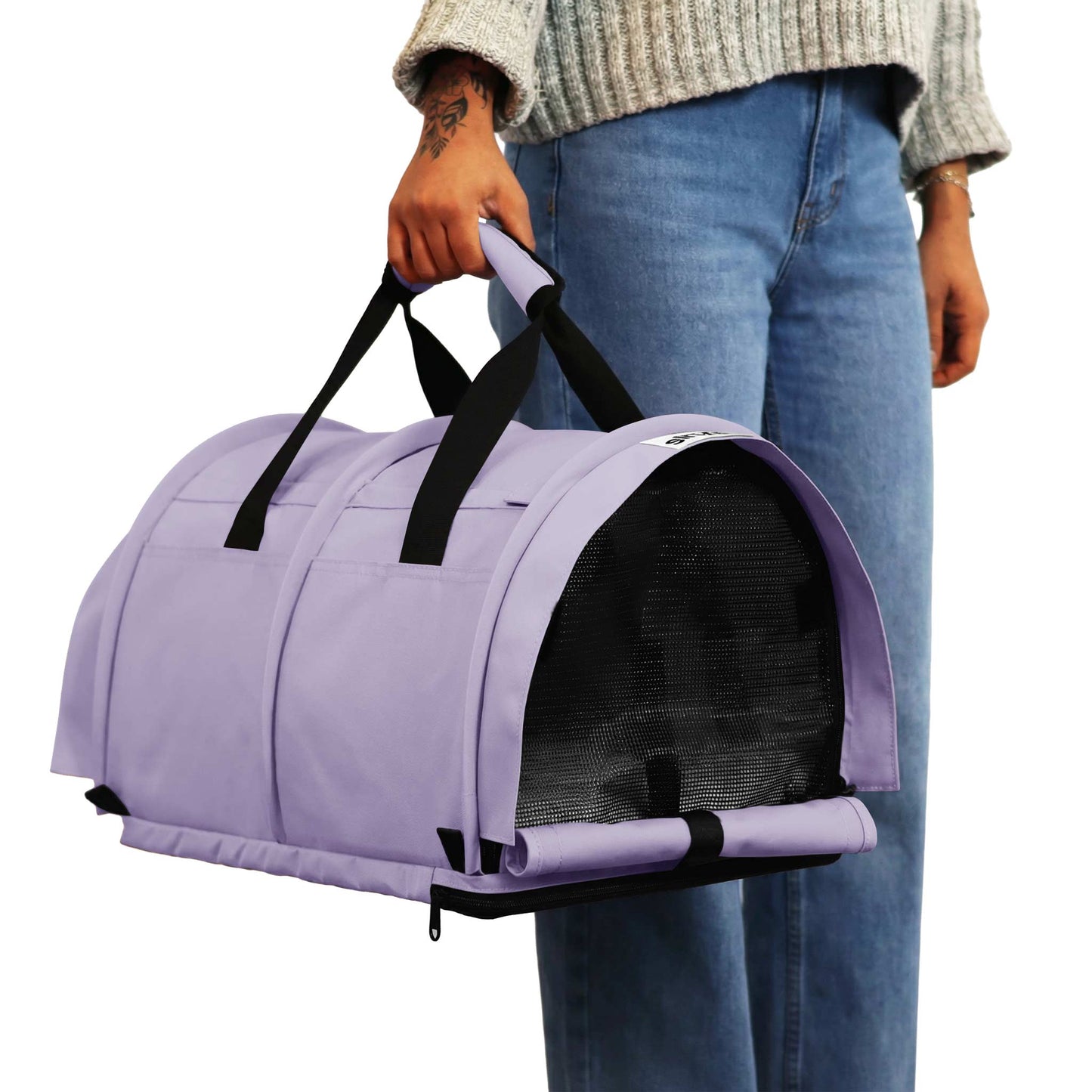 Person holding a lavender SturdiBag Pro 3.0 soft-sided pet carrier with black mesh and handles.