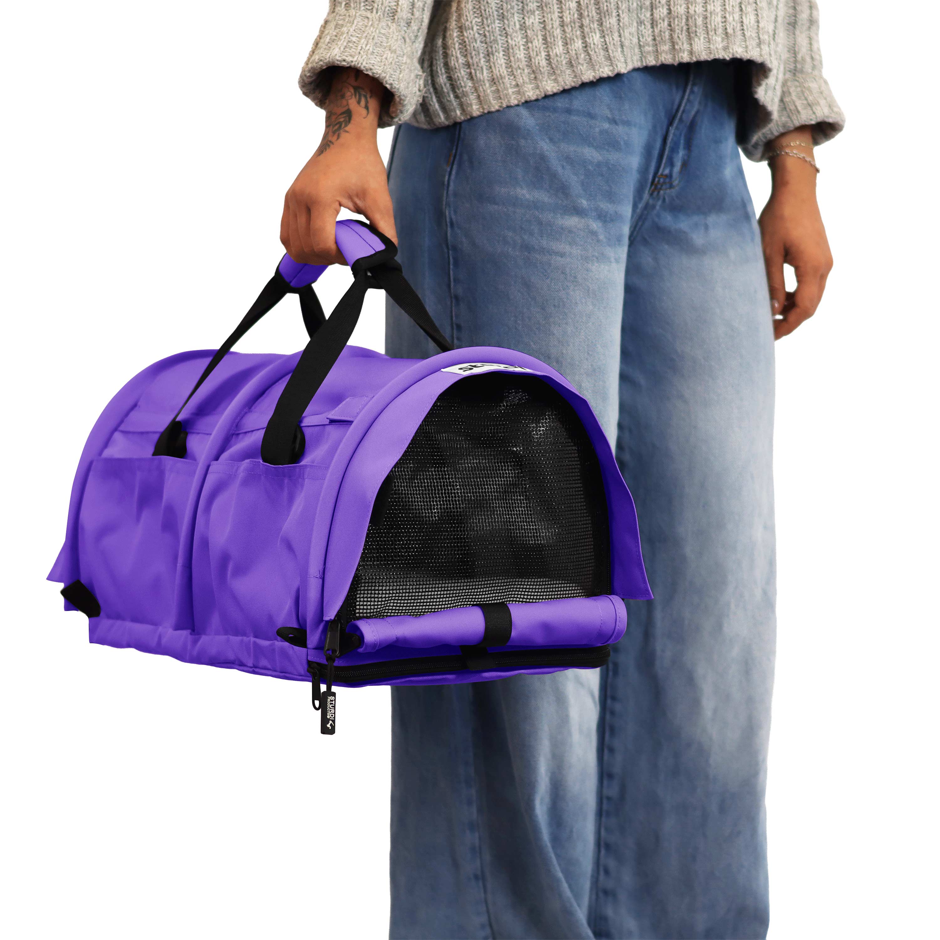 Person holding a vibrant purple SturdiBag Pro 3.0 soft-sided pet carrier with mesh window.