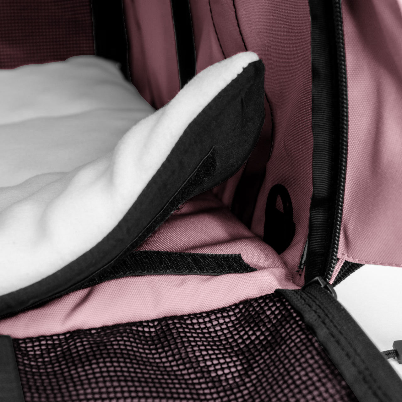 Pink SturdiBag Pro 3.0 pet carrier interior with white fleece pad, black mesh, and zipper.