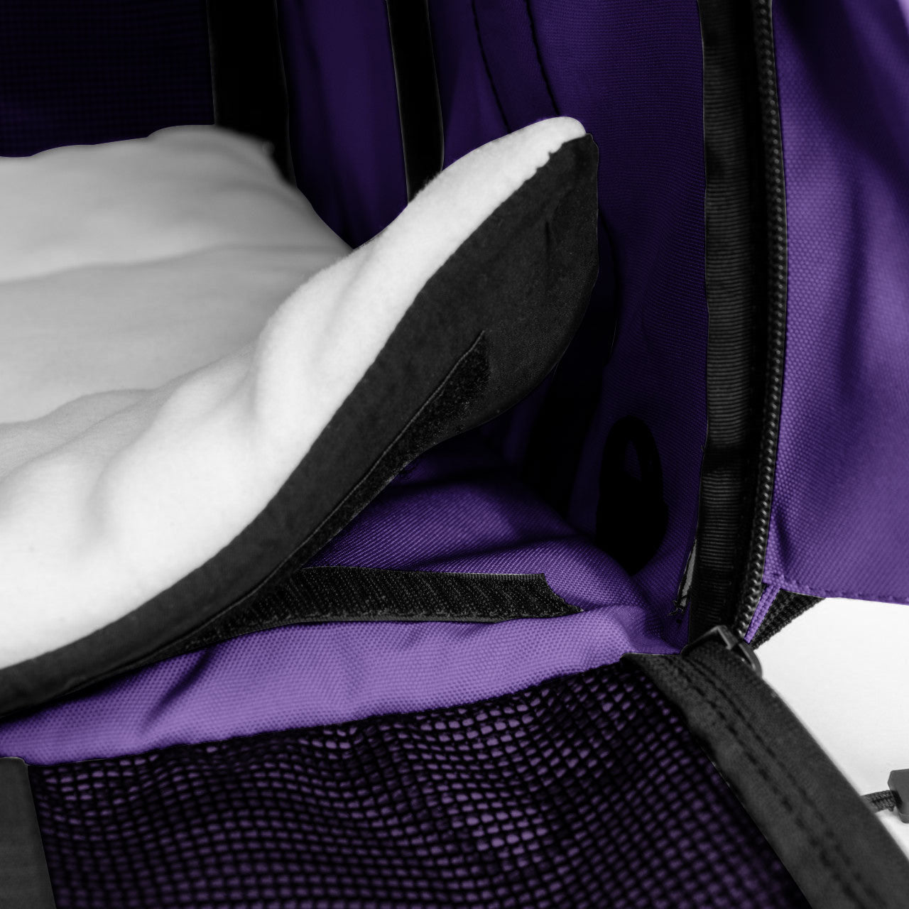 Purple SturdiBag Pro 3.0 pet carrier interior with a white fleece comfort pad and black mesh pocket.