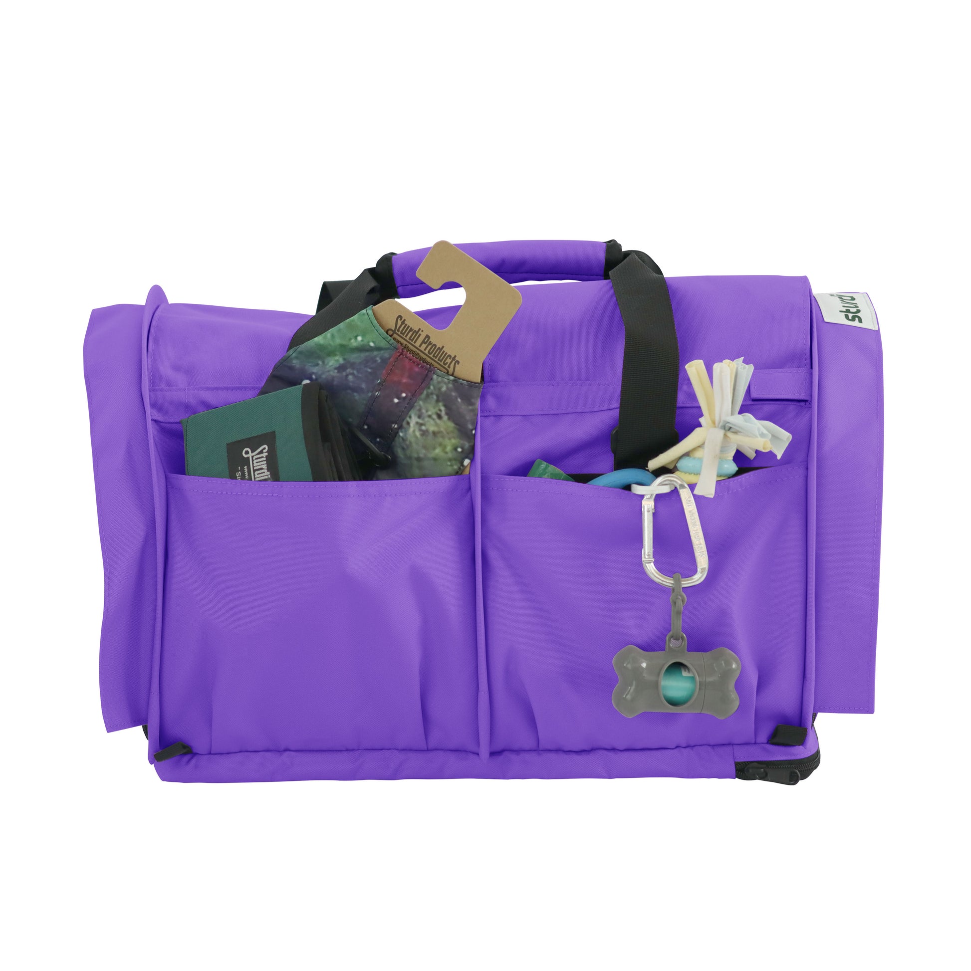 Purple SturdiBag Pro 3.0 pet carrier with front pockets holding pet essentials and a bone-shaped dispenser.