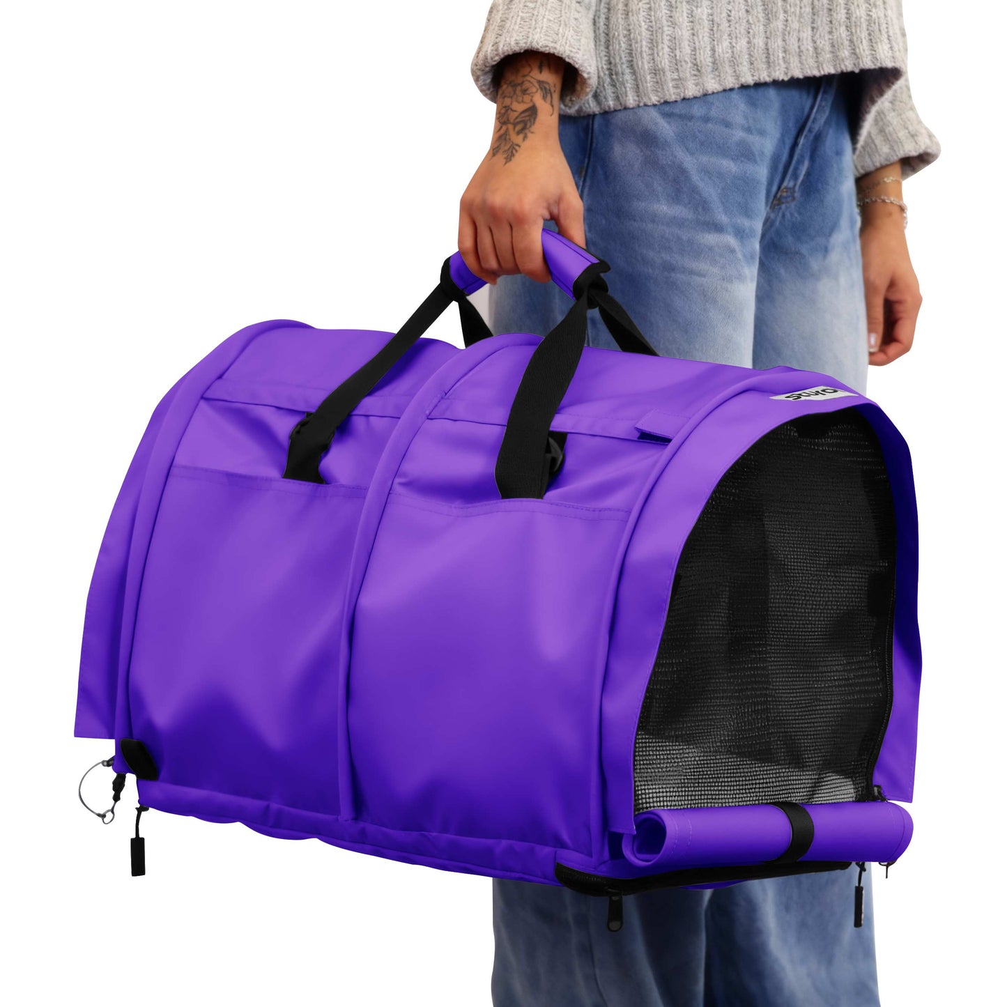 Purple SturdiBag Pro 3.0 soft-sided pet carrier with mesh window, held by a person.