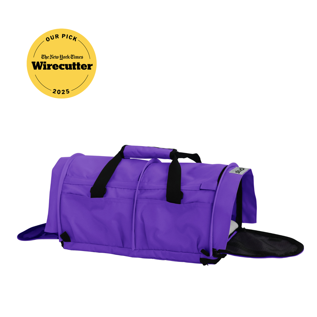 Purple SturdiBag Pro 3.0 soft-sided pet carrier with mesh panels, top handle, and shoulder strap.