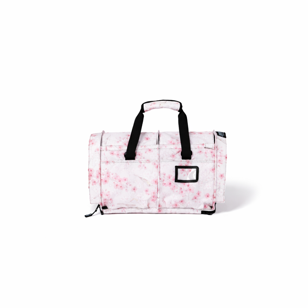 SturdiBag Pro 3.0 pet carrier with a pink cherry blossom pattern, black straps, and mesh window.