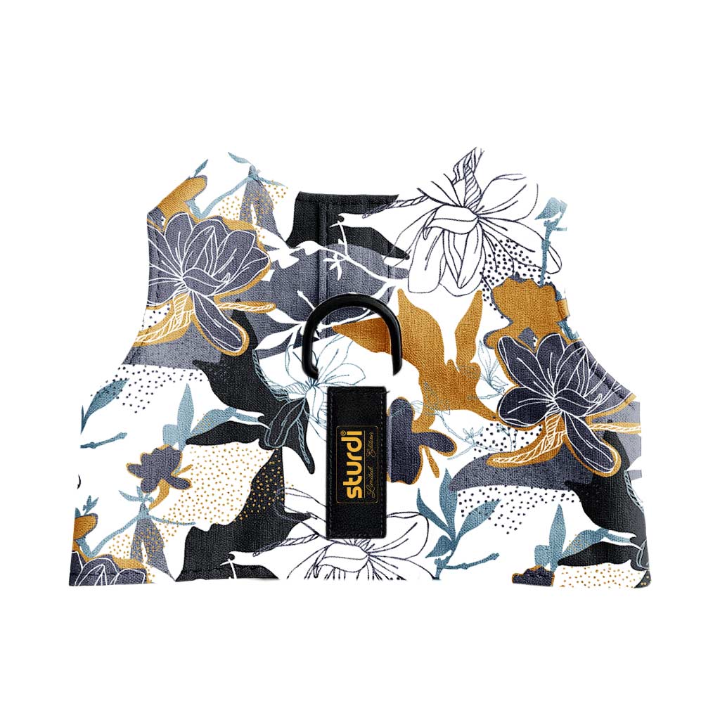 Sturdi Walking Vest in a white, gold, and grey floral print with a black D-ring and logo tag.